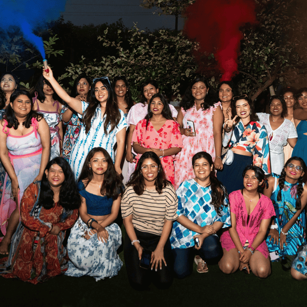SHAPE Lingerie team standing together outdoors at night with coloured smoke flares