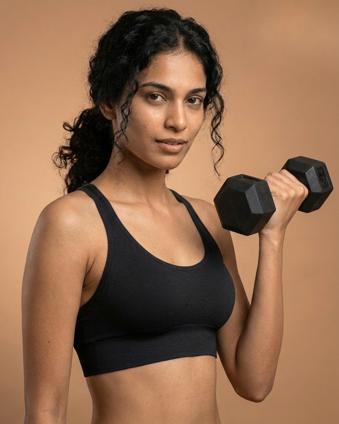 Easy Fit Sports Bra in Black, worn by a model lifting a dumbbell, SHAPE Lingerie