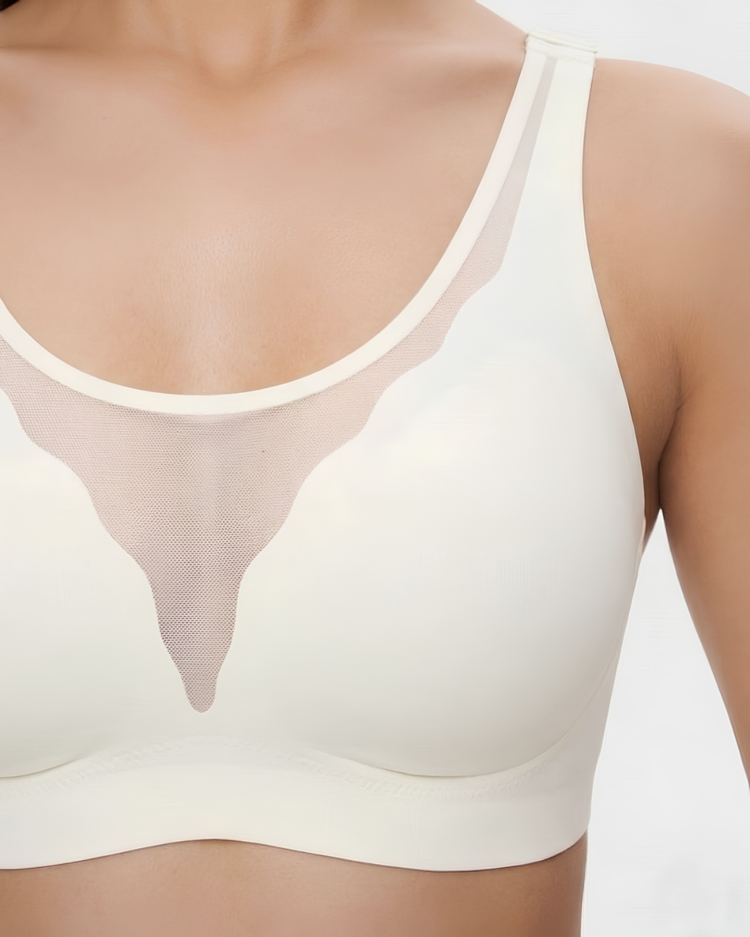Close-up of the mesh neckline on the GlowCut Seamless Bra in Beige, worn by a model, SHAPE