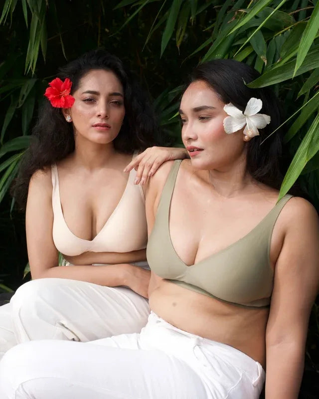 Two models wearing nude and sage SHAPE Plunge Lite bras outdoors